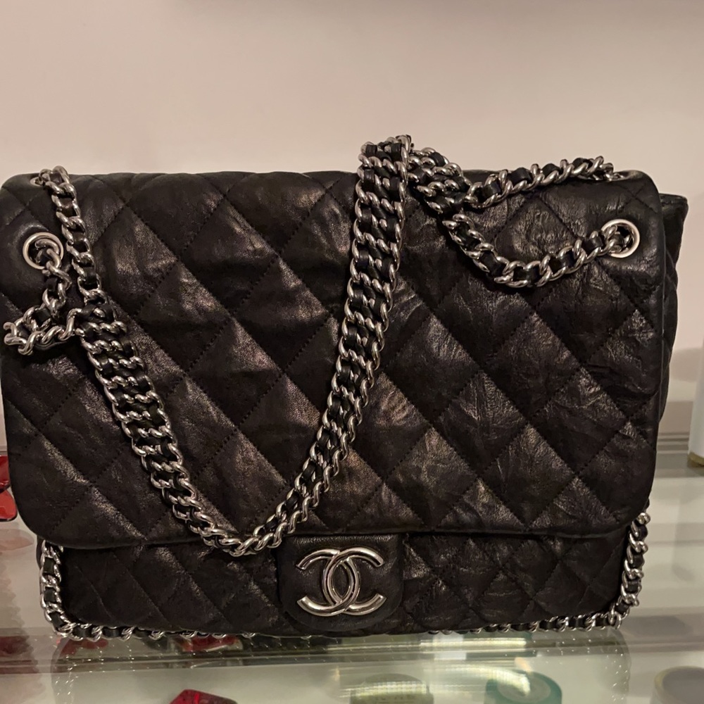 Chanel Chain around black flap maxi handbag.